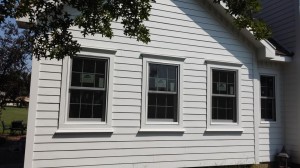 Repaired the woodr rot damage and then Installed Hardie lap siding and Quaker Windows